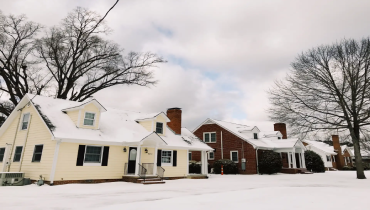 Two homes side-by-side in a winter landscape.