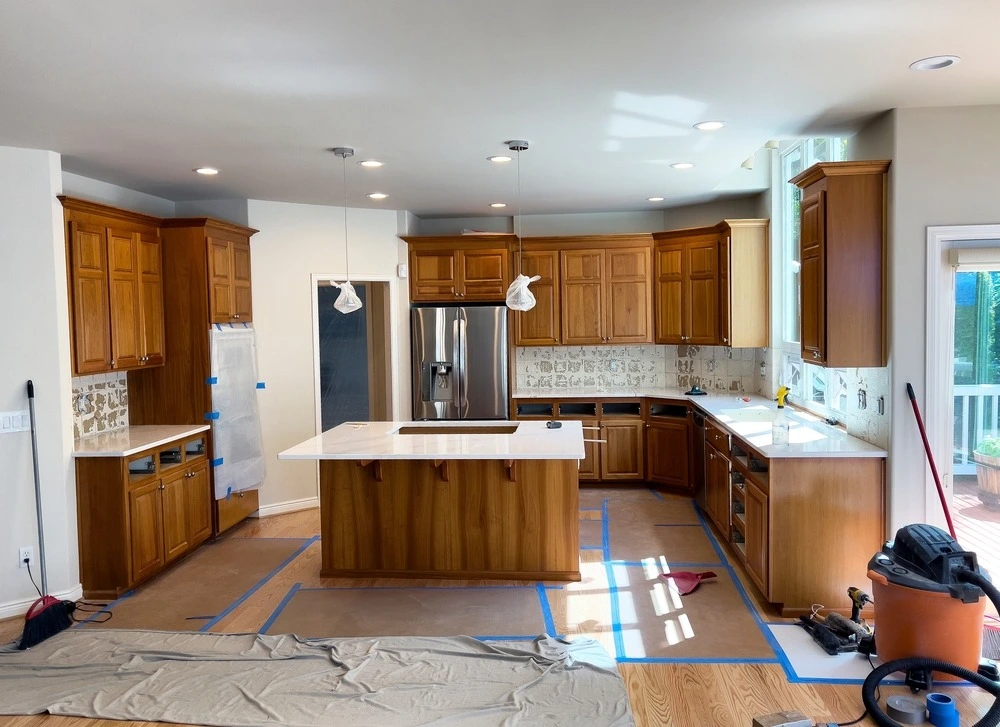 Kitchen during remodel with vacuum and floor coverings.